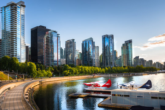 View of Vancouver Waterfront at Sunset with Two Seaplanes moorred to a Jetty. British Columbia,Canada.