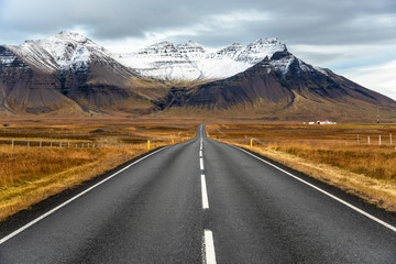 Towering Mountains along a Deserted Road in Iceland on a Cloudy Autumn Day