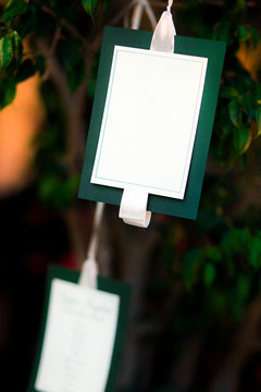 Segna posto  bianco e verde appeso ad un albero