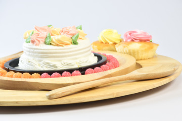Vanilla Cake Make up with beautiful flowers put in the dish. on the White Blackground