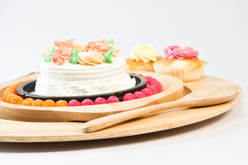 Vanilla Cake Make up with beautiful flowers put in the dish. on the White Blackground