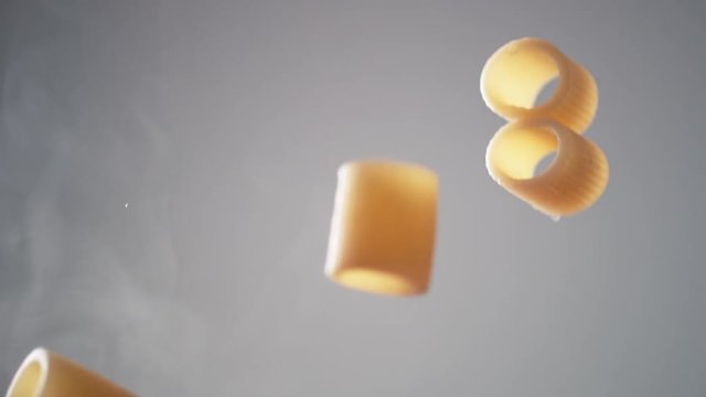 Camera follows cooking mezze maniche rigate pasta in tomato sauce. Shot with high speed camera, phantom flex 4K. Slow Motion.