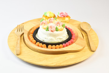 Vanilla Cake Make up with beautiful flowers put in the dish. on the White Blackground