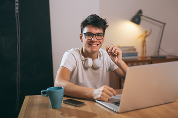 teenage boy using laptop at his home