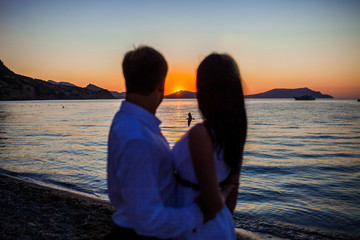 Couple in love on sunset background