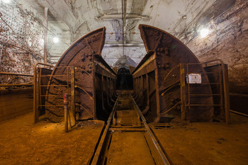 Fototapeta na wymiar Underground gold iron ore mine shaft tunnel gallery passage with wagon rotating machine