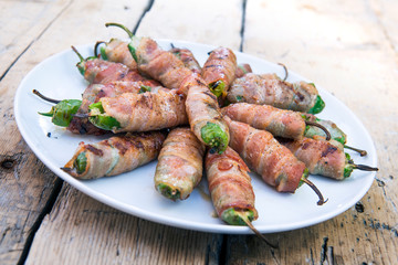 Dish with Grilled Peppers stuffed and covered with bacon