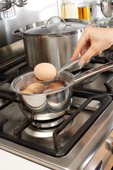 WOMAN BOILING EGGS