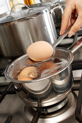 WOMAN BOILING EGGS