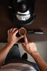 Fototapeta na wymiar Photo of coffee maker, man hand pouring coffee