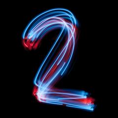 The neon number one, blue light image, long exposure with colored fairy lights, against a black...