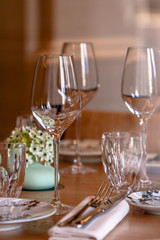 Table setting in a French restaurant. View through a window from a street.