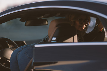 Portrait of woman in sunglasses in car