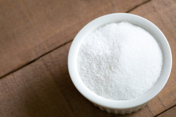 Top down view on a ramekin dish of granulated sugar