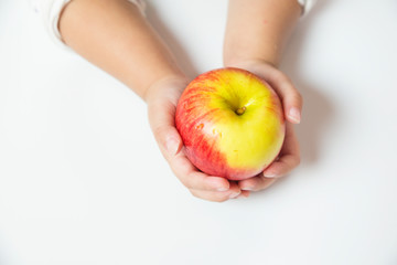 Hand holding Red apple on white background