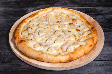 Four Cheese Pizza, mozzarella, cheddar, cream on a black background