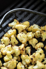 Roasted cauliflower in a barbecue grill basket