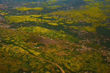 Beautiful valley of Kashmir, India. Stunning view of  mustard field on the ground ,tourist and travel concept.(view from aircraft)