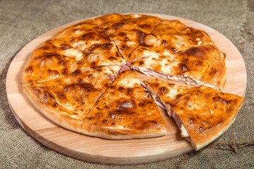 stuffed closed Calzone Pizza on a natural background