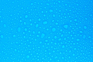 Fototapeta na wymiar closeup drops water on blue background