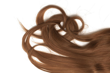 A strands of long, twisted, brown hair isolated on white background
