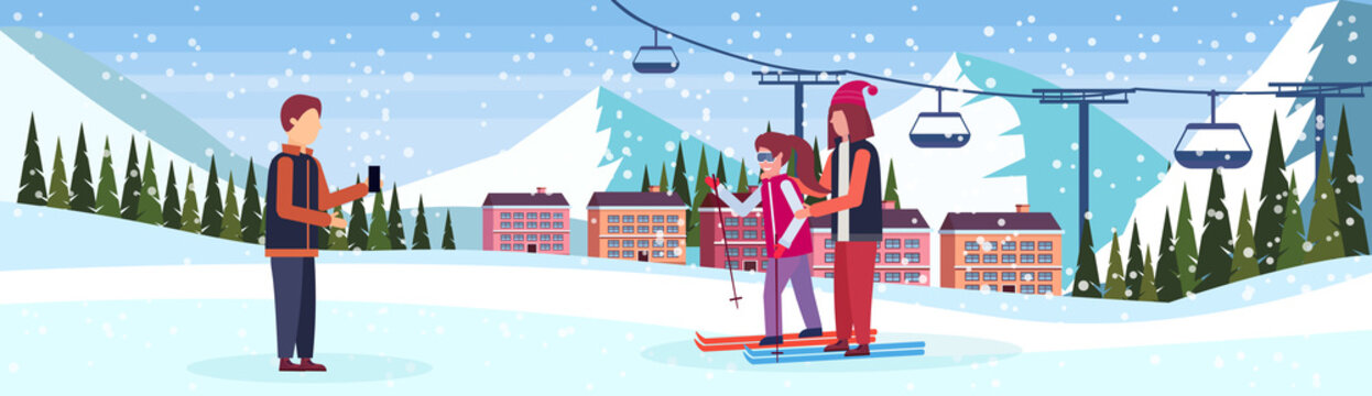 man taking photo skiers couple ski resort hotel houses buildings cable car chairlift snowy mountains fir tree landscape winter vacation flat horizontal banner