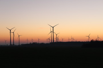 Wind farm in front of autumnal red sunset