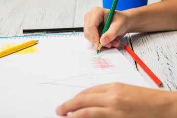 Kids drawing and lots of pencils for drawing on wooden background.