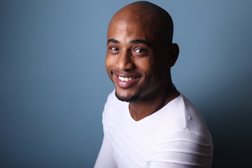 Black man in front of a colored background