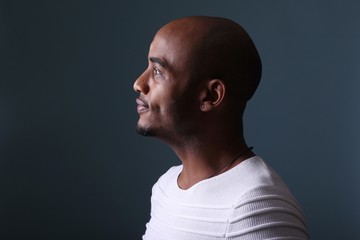 Black man in front of a colored background