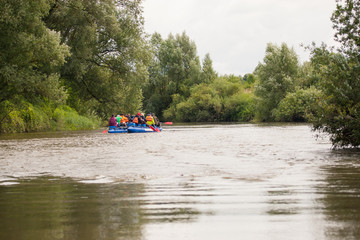 Fototapeta na wymiar photo of people who float along the river and sprint on a catamaran