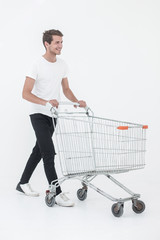 smiling man pushing shopping cart.