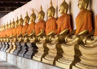 Row of Golden Buddha in ancient city of Thailand