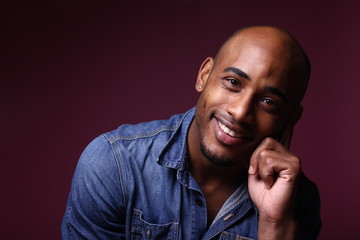 Black man in front of a colored background