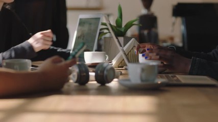 close up business people hands students using computer technology in cafe browsing working together brainstorming creative project ideas studying online research enjoying busy coffee shop