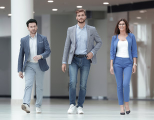 successful employees walk in the office hall