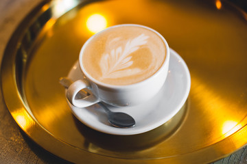 A mug of fragrant cappuccino brought by the waiter