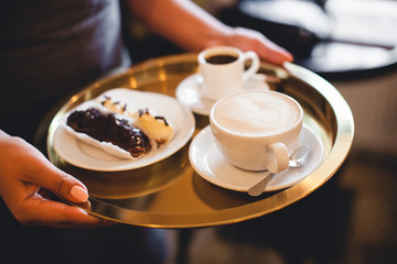 A mug of fragrant cappuccino brought by the waiter