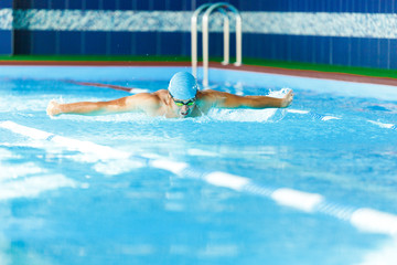 Photo of sportive man swimming in pool