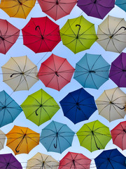 bottom view of colored umbrellas in the blue sky 