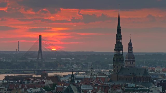 Sunset cityscape of Riga, Latvia. Car traffic on a Stone Bridge, Town hall and the Old city. 4K, UHD
