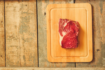 beef steak raw (Grilled meats with spices) - a piece of meat. Top view with copy space