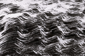 Black with grey ink texture with abstract washes and brush strokes on white watercolor paper background.