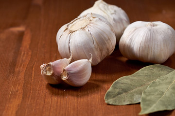 Garlic and garlic cloves on wooden background. Selective focus