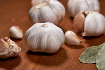 Garlic and garlic cloves on wooden background. Selective focus