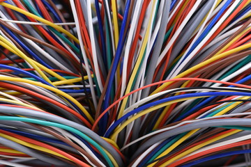 Bundle of colorful wires and cables closeup, used in telecommunication network and electrical systems