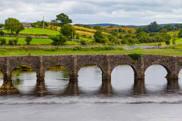River, stone bridge and farms in background, Great Western Greenway trail