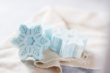 Handmade soap in the form of snowflakes, natural cosmetics concept. Place for text.