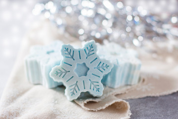 Fototapeta na wymiar Handmade soap in the form of snowflakes, natural cosmetics concept. Place for text.