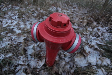 close up of a big red fire hydrant, outdoors on a winter day in Poland, Europe